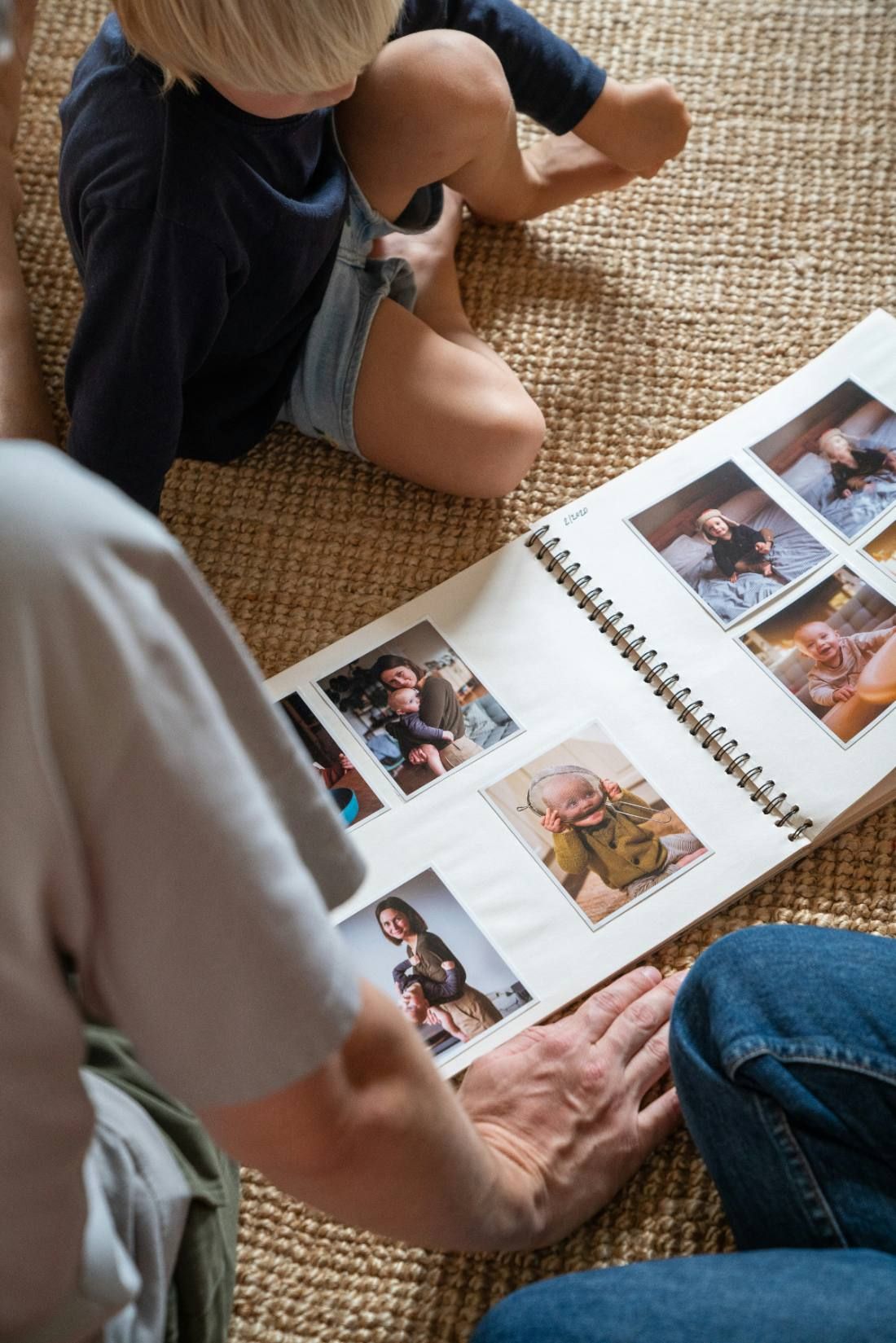 An open photo album lying on the floor