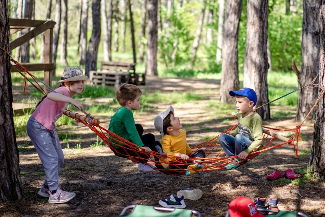 Campers resting in hammocks between trees