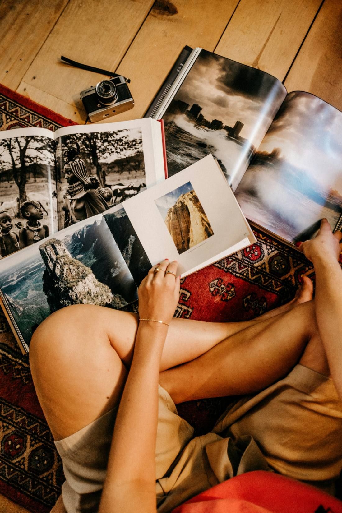 A stack of printed photo books on a rug