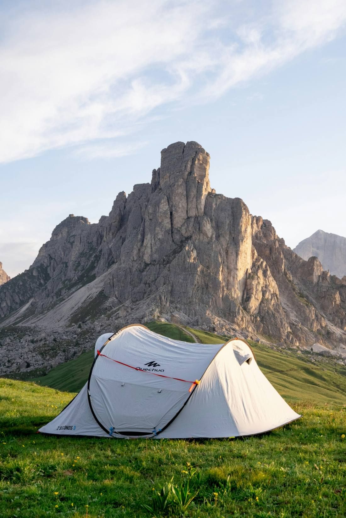 A tent pitched in the mountains at sunrise